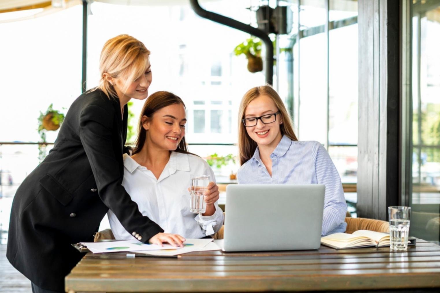 Modern office space with financial planning materials and strategic documents spread across a conference table